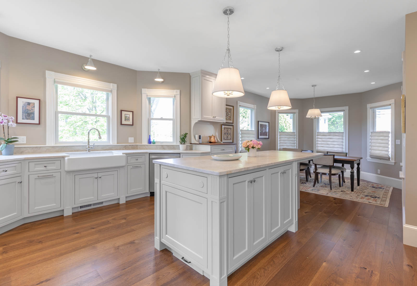 A large well lit kitchen with white cabinets